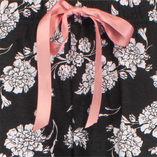 Close-up van een zwarte pyjamabroek met witte bloemenprint en een roze strik met linten.