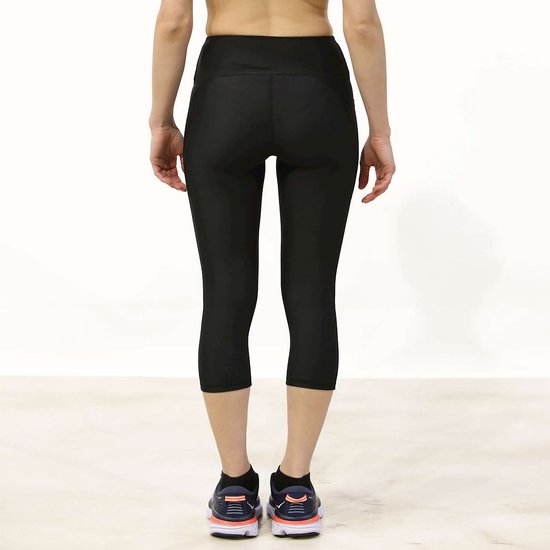 Zwarte Under Armour capri sportbroek, achterkant, gedragen door een vrouw.