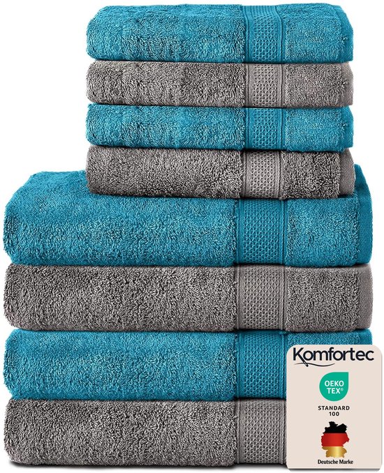 Pile de serviettes turquoise et gris anthracite, avec logos "Komfortec" et "OEKO-TEX".