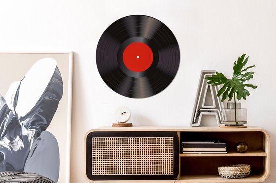 Zwarte vinyl LP met rood middellabel, hangend aan een muur boven een dressoir.