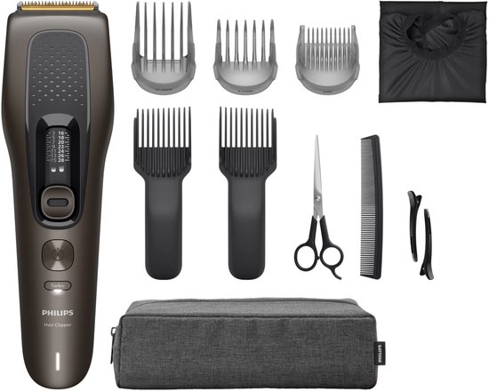 Philips 9000-serie tondeuse met diverse opzetkammen, kappersschaar, kam, clips, cape en een grijze opbergtas.