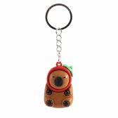 Bruine capybara sleutelhanger met rode hoed en groene pompon.