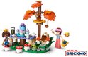 LEGO Friends speelset met twee poppen, een eekhoorn in een boom, en een theetafel met cupcakes.