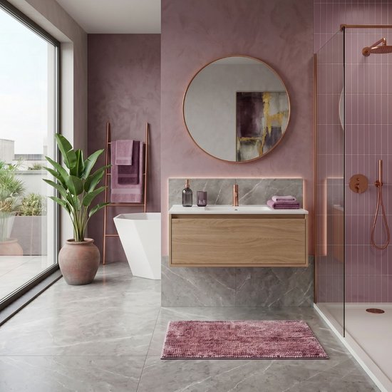 Moderne badkamer met een vrijstaand bad, een houten wastafelmeubel met rozetint, een ronde spiegel en een douche met roze tegels.
