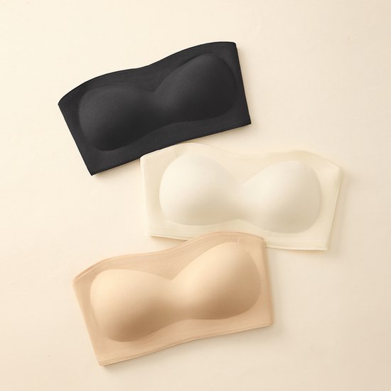 Drie strapless, beugelloze push-up bh's in zwart, wit en huidskleur.