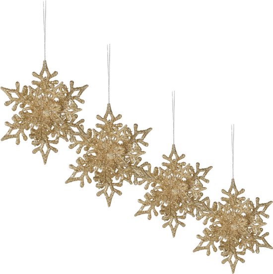 Vier champagnekleurige, glitterende sneeuwvlokdecoraties hangend.
