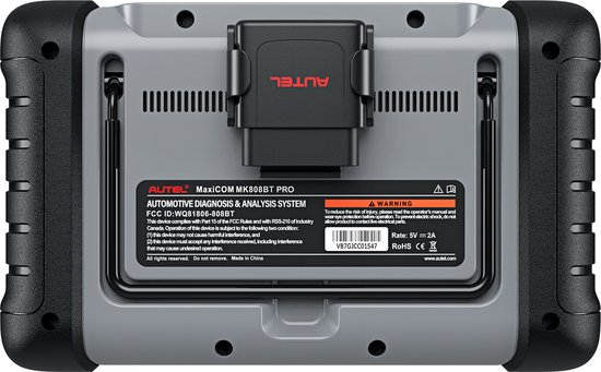 Achterkant van de grijze Autel MaxiCOM MK808BT PRO diagnose tablet met zwart omhulsel. Details met serienummer, waarschuwingen en 'Autel' logo.