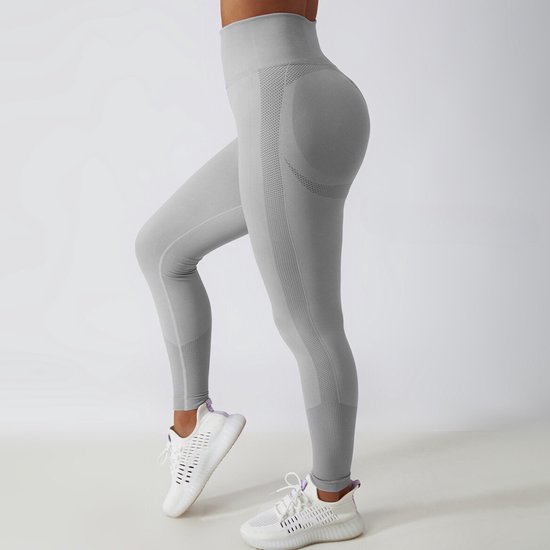 Grijze sportlegging, hoge taille, geribbelde tailleband en mesh details.