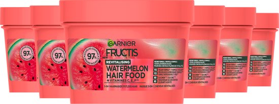 Groupe de six pots Garnier Fructis Revitalising Watermelon Hair Food sur fond rose.