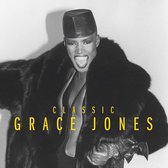 Grace Jones draagt een zwarte bontjas en hoed. Tekst: CLASSIC GRACE JONES.
