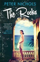 Boek "The Rocks" van Peter Nichols met een vrouw in een wit jurkje dat uitkijkt over de oceaan, met een citaat van Rachel Joyce.