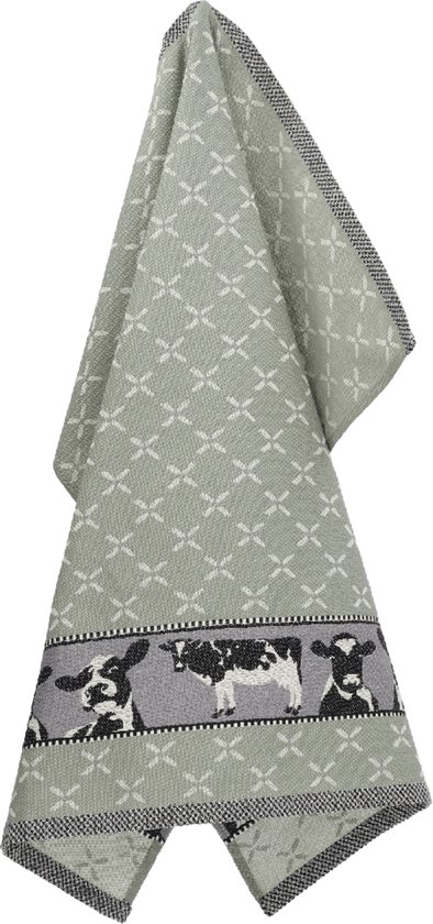 Torchon vert clair avec un motif de trèfles blancs et une bordure de vaches noires et blanches.