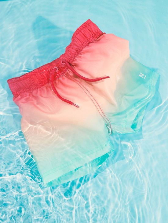 Zwemshort in rood, oranje en blauw verloop met trekkoord in het water.