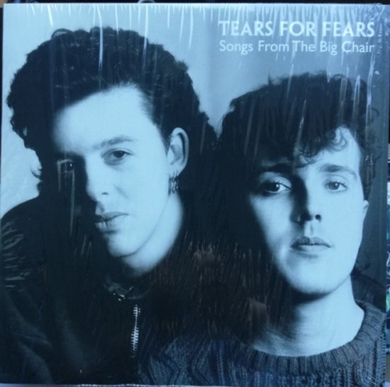 Een hoes met een zwart-wit portret van twee mannen, "TEARS FOR FEARS Songs From The Big Chair" staat rechtsboven. De hoes is verpakt in plasticfolie.