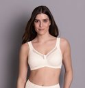 Crème beugelvrije bh met brede bandjes en mesh-inzet bij de cups.
