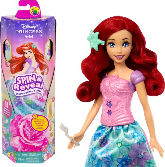 Ariel pop met rode krullende haren en paars/blauwe bloemenjurk, naast de Spin & Reveal verpakking.