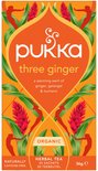 Pukka three ginger biologische thee verpakking, oranje met gember bloemen en bladeren.
