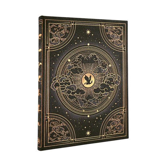 Carnet noir avec un motif céleste doré, des nuages et un oiseau au centre.
