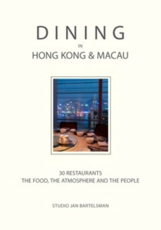 Boek 'Dining in Hong Kong & Macau' met op de cover een foto van een gedekte tafel met uitzicht op de skyline van Hong Kong bij nacht.