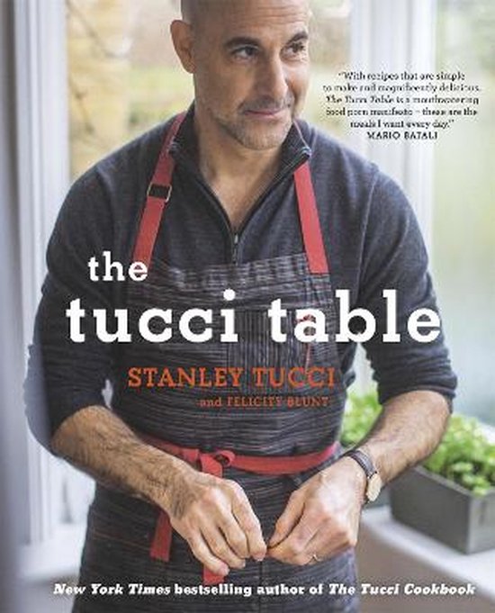 De voorkant van het boek 'the tucci table' met Stanley Tucci in een schort.