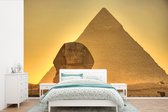 Behang - Fotobehang De sfinx van Giza in Egypte bij avondlicht - Breedte 600 cm x hoogte 400 cm