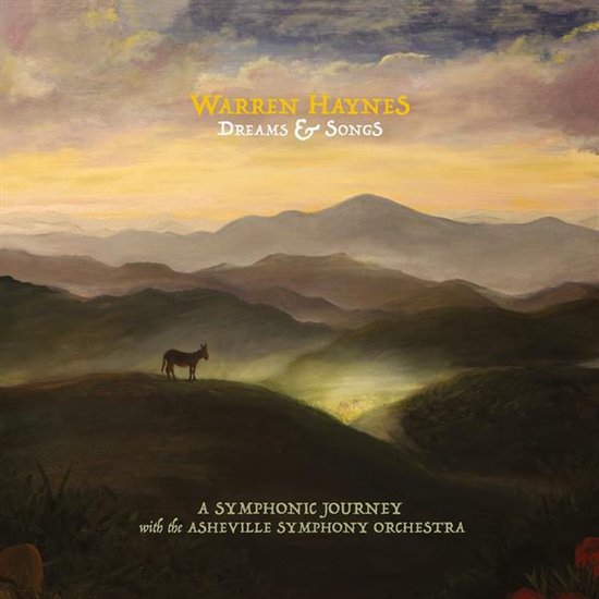 Schilderij van een ezel in een heuvelachtig landschap bij zonsondergang, met de tekst 'Warren Haynes Dreams & Songs'.