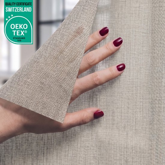 Hand met bordeauxrode nagellak houdt lichtgrijze raamfolie met textielstructuur omhoog.