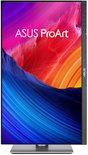 ASUS ProArt monitor in portretmodus met zilveren standaard en kleurrijk scherm.