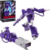 Shockwave actiefiguur in robot- en voertuigvorm naast de originele productverpakking.