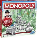 Monopoly bordspel met Monopoly-figuur, zilveren pionnen waaronder een eend, hond en hoed, en tekst Nieuw assortiment pionnen.
