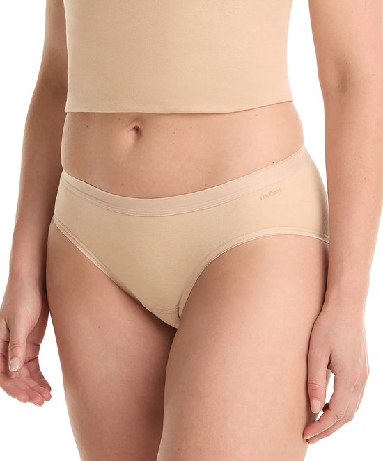 Model draagt een nude bikinislip van Ten Cate met een lichtbruine tailleband.