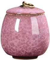 Roze keramieken mini urn met een deksel, gouden ring en mozaïekpatroon.