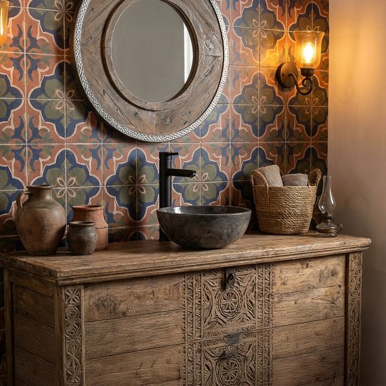 Baignoire en marbre avec robinet noir mat sur une commode ancienne en bois avec des carreaux colorés.