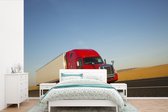 Behang - Fotobehang Rood gekleurde vrachtwagen - Breedte 525 cm x hoogte 350 cm
