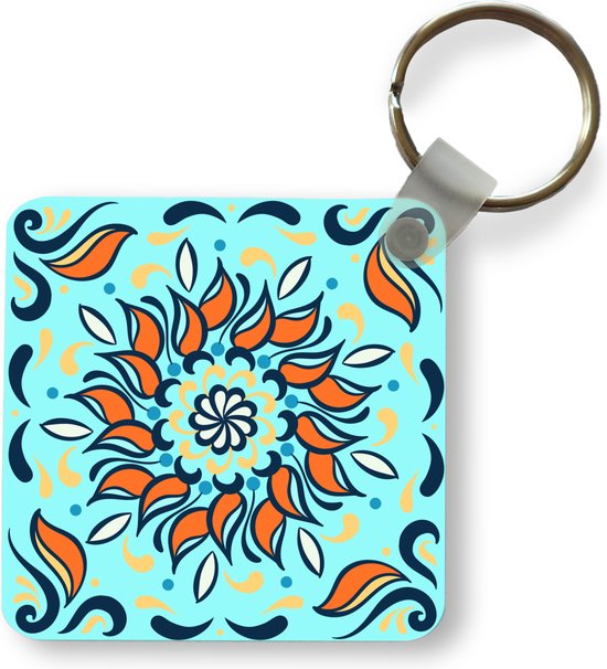 Porte-clés - motif sur fond bleu clair avec une fleur orange et des décorations - Plastique - Rond