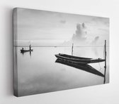 Black and white scene of a traditional fishing boat in Tumpat, Malaysia, with the silhouette of the fisherman standing on the boat. Soft focus due to long exposure - Modern Art Can