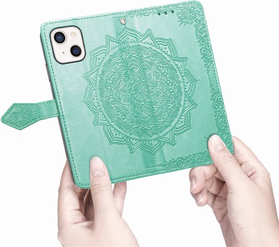 Étui de téléphone vert à motif floral, tenu en main, avec fermeture magnétique.