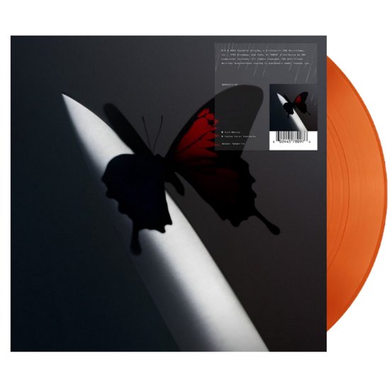 Oranje 2LP vinyl met de titel 'Twelve Carat Toothache'. De hoes toont een zwarte vlinder met rode accenten op een witte punt, met regen op de achtergrond.