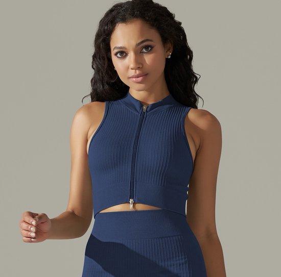 Blauw, geribd, mouwloos sporttopje met rits tot aan de halslijn, gedragen door een vrouw.