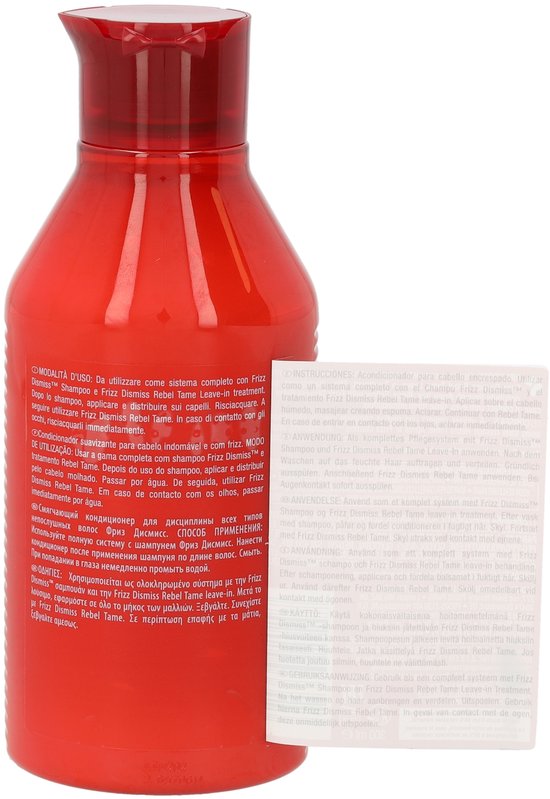 Flacon rouge Redken Frizz Dismiss avec instructions produit multilingues.
