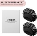 Twee zwarte satijnen slaapmutsjes met zwarte elastische band, naast een witte Beyeza geschenkverpakking.