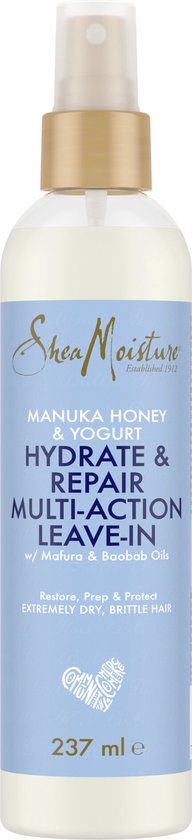 Een fles Shea Moisture Manuka Honey & Yogurt Hydrate & Repair Multi-Action Leave-In spray met gouden dop en blauw label.