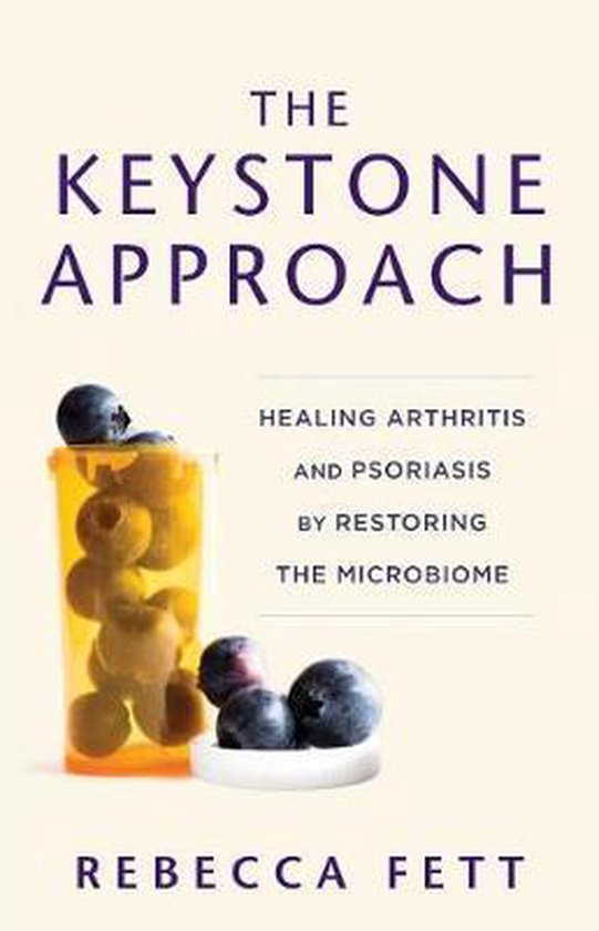 Livre 'The Keystone Approach' avec une boîte de pilules remplie de myrtilles et des myrtilles éparpillées à côté. Le titre est 'The Keystone Approach: Healing Arthritis and Psoriasis by Restoring the Microbiome'. Écrit par Rebecca Fett.