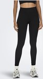 Model met zwarte, nauwsluitende sportlegging met hoge taille en geribd patroon, en witte sneakers.