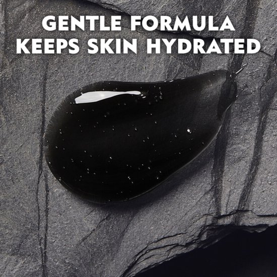 Een druppel zwarte douchegel met kleine luchtbelletjes op een donkergrijs, rotsachtig oppervlak. Tekst: 'GENTLE FORMULA KEEPS SKIN HYDRATED'.