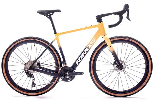Gravelbike met gele en zwarte fade kleurstelling, "RINOS" logo en bruine banden.