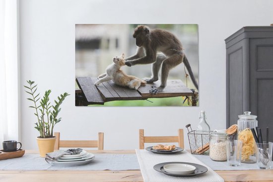 Toile de singe tirant les oreilles de chat 2cm 120x80 cm - Tirage photo sur toile (Décoration murale salon / chambre) / Peintures sur toile pour Animaux domestiques