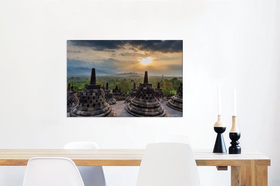 Canvas Schilderij Zonsondergang boven de groene bomen bij de Borobudur - 60x40 cm - Wanddecoratie