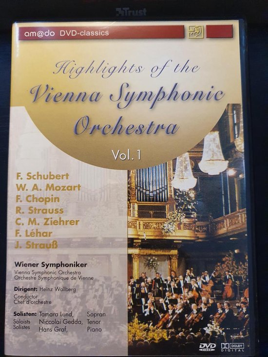 DVD-hoes met de tekst "Highlights of the Vienna Symphonic Orchestra Vol. 1" in gele letters. Een orkest en publiek zijn zichtbaar op de achtergrond.