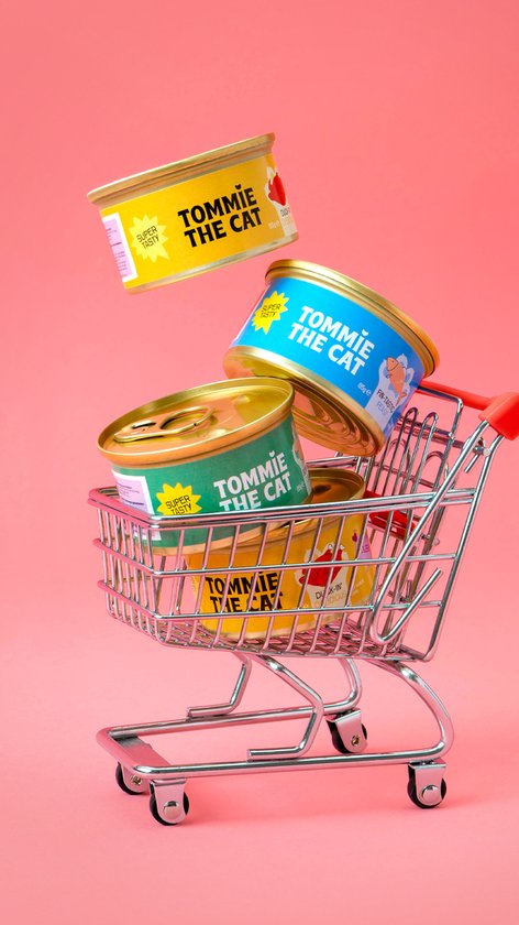 Drie blikjes 'Tommie the Cat' in verschillende kleuren (geel, blauw, groen) in een winkelwagentje.